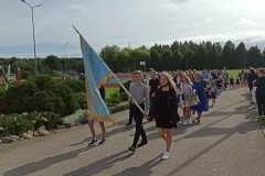 Skolēni nes skolas karogu